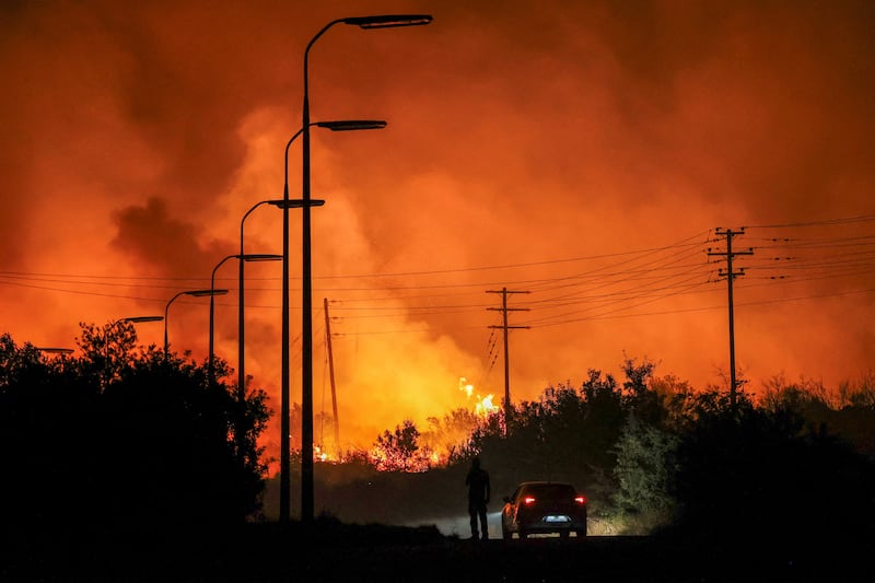A wildfire burns in central Greece last month. Climate change is a huge threat but also presents a tremendous opportunity for investors across a range of sectors. Reuters