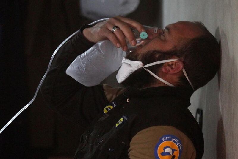 A civil defence member breathes through an oxygen mask, after the gas attack in the town of Khan Sheikhun in April. Ammar Abdullah / Reuters