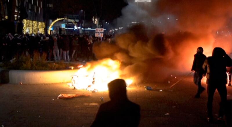 Police fired warning shots, injuring an unknown number of people, as riots broke out in central Rotterdam. Photo: Media TV Rotterdam via AP