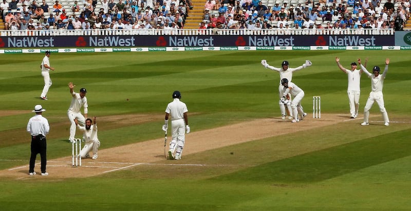 England leg-spinner Adil Rashid celebrates the wicket of India's Ishant Sharma with teammates. Reuters