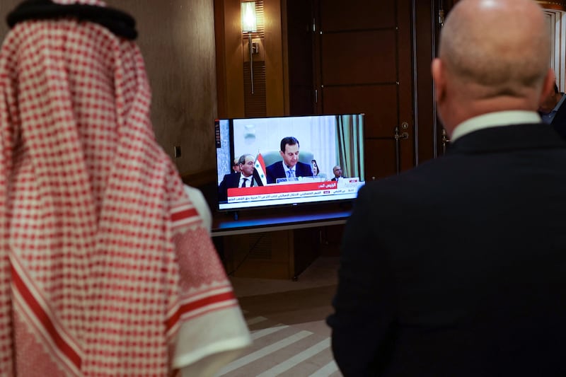 Media delegates watch on a screen Syrian President Bashar Al Assad addressing the Arab League summit in Jeddah this month. AFP