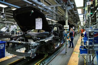 (FILES) This file photo taken on August 25, 2020 shows employees working on the production line of Swedish automaker Volvo Cars's Torslanda production plant in Gothenburg. Consumer goods from smartphones to consoles could rise in price due to microchip shortages caused by a "perfect storm" of coronavirus-driven demand, supply chain disruptions and trade war stockpiling, experts warned on February 18, 2021. - TO GO WITH Asia-economy-semiconductors-technology,FOCUS by Sam REEVES
 / AFP / Jonathan NACKSTRAND / TO GO WITH Asia-economy-semiconductors-technology,FOCUS by Sam REEVES
