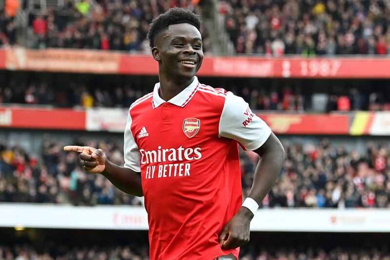 Arsenal's English midfielder Bukayo Saka celebrates after scoring their second goal during the English Premier League football match between Arsenal and Crystal Palace at the Emirates Stadium in London on March 19, 2023.  (Photo by JUSTIN TALLIS / AFP) / RESTRICTED TO EDITORIAL USE.  No use with unauthorized audio, video, data, fixture lists, club/league logos or 'live' services.  Online in-match use limited to 120 images.  An additional 40 images may be used in extra time.  No video emulation.  Social media in-match use limited to 120 images.  An additional 40 images may be used in extra time.  No use in betting publications, games or single club/league/player publications.   /  