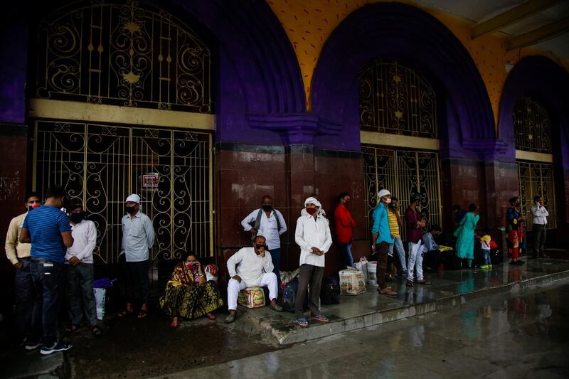 Stranded passengers wait outside Howrah railway station closed due to coronavirus lockdown in Kolkata, India. AP Photo