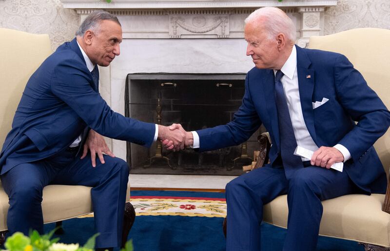 US President Joe Biden shakes hands with Iraqi Prime Minister Mustafa Al Kadhimi at the Oval Office at the White House in Washington.