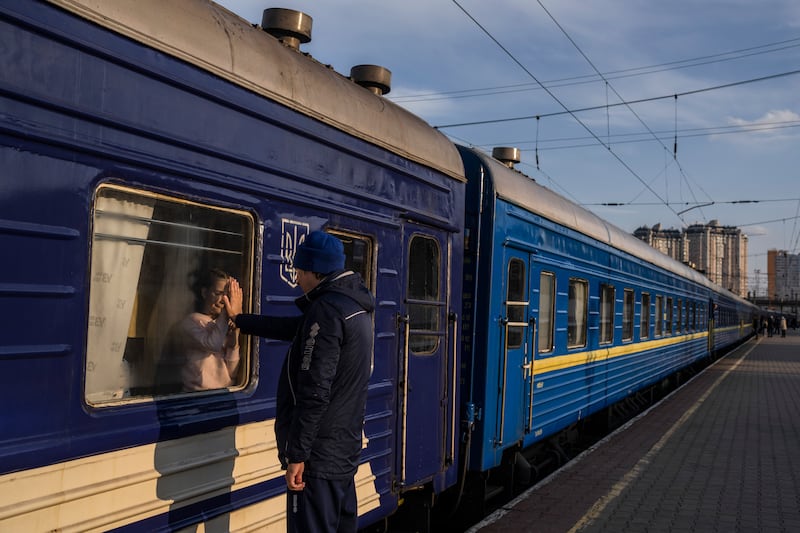 Ruslan Mishanin, 36, bids farewell to his nine-year-old daughter as the train with his family leaves Odesa for Poland in April