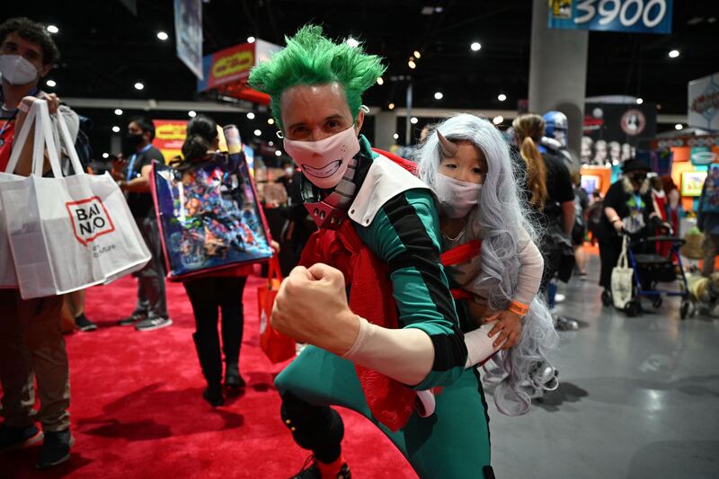 A cosplayer and his daughter portray Deku and Eri from 'My Hero Academia'. AFP