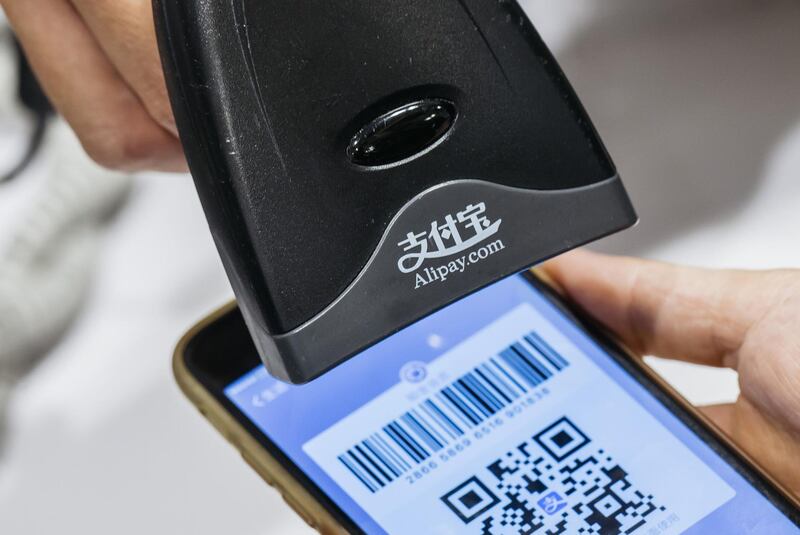 An employee scans a quick response (QR) code displayed on the Ant Financial Services Group's Alipay app, an affiliate of Alibaba Group Holding Ltd., inside a Sa Sa International Holdings Ltd. store in an arranged photograph in Hong Kong, China, on Tuesday, Nov. 1, 2016. The urgency to prepare regulatory environments for fintech is growing as banks begin offering digital services such as biometric authentication and as mobile-payment systems such as Apple Pay and AliPay are introduced around the region. Photographer: Anthony Kwan/Bloomberg