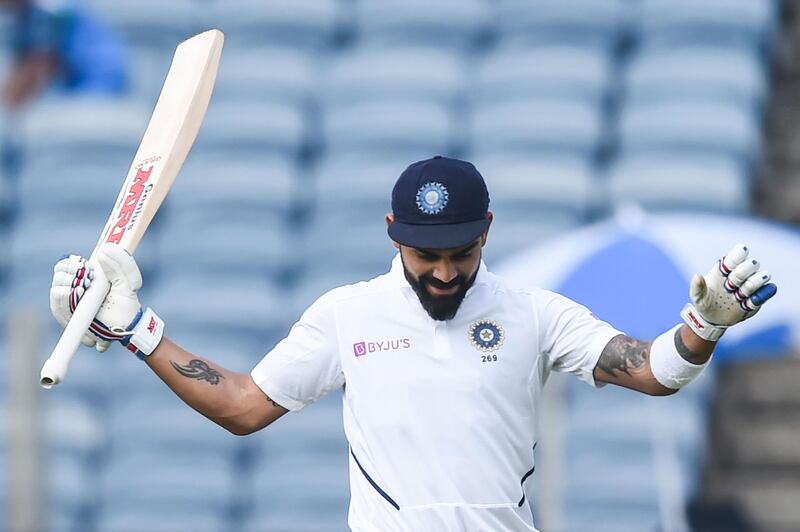 India's cricket team captain Virat Kohli celebrates after scoring a double century (200 runs) during the second day of the second Test cricket match between India and South Africa at Maharashtra Cricket Association Stadium in Pune on October 11, 2019. IMAGE RESTRICTED TO EDITORIAL USE - STRICTLY NO COMMERCIAL USE
 / AFP / Punit PARANJPE / IMAGE RESTRICTED TO EDITORIAL USE - STRICTLY NO COMMERCIAL USE
