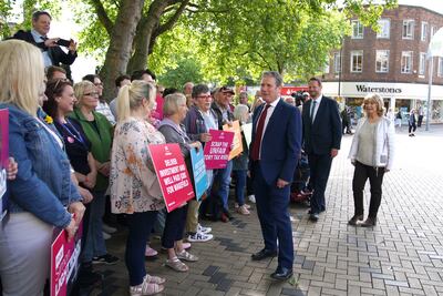 Labour leader Sir Keir Starmer talking to locals on the Wakefield by-election campaign trail with Labour candidate Simon Lightwood, left, and local councillor Denise Jeffrey, right. PA