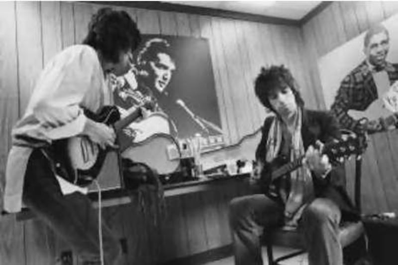 1978 image of Ronnie Wood and Keith Richards playing Guitars. CORBIS
