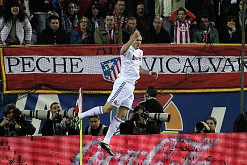 Real Madrid's in-from striker Karim Benzema celebrates his goal in front of Atletico fans.