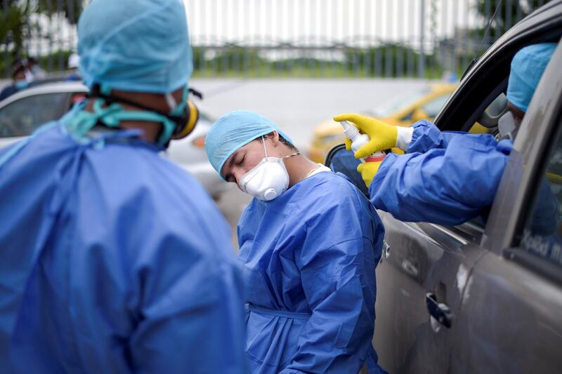 A hospital worker is sprayed with disinfectant at Guasmo Sur General Hospital after Ecuador reported new cases of coronavirus disease (COVID-19), in Guayaquil, Ecuador. REUTERS