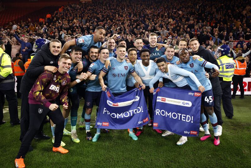 Burnley players celebrate promotion to the Premier League following the Sky Bet Championship match at the Riverside Stadium, Middlesbrough. PA