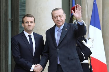 In this file photo taken on January 5, 2018 French President Emmanuel Macron (L) greets his Turkish counterpart Recep Tayyip Erdogan upon his arrival at the Elysee palace in Paris. AFP