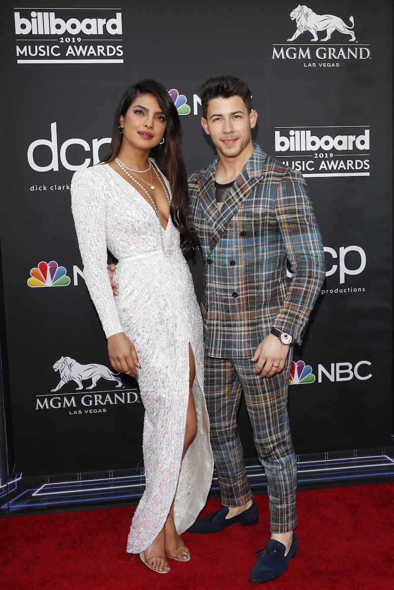 epa07541613 Indian singer Priyanka Chopra (L) and US singer Nick Jonas (R) arrive for the 2019 Billboard Music Awards at the MGM Grand Garden Arena in Las Vegas, Nevada, USA, 01 May 2019. The Billboard Music Awards finalists are based on US year-end chart performance, sales, number of downloads and total airplay.  EPA/NINA PROMMER