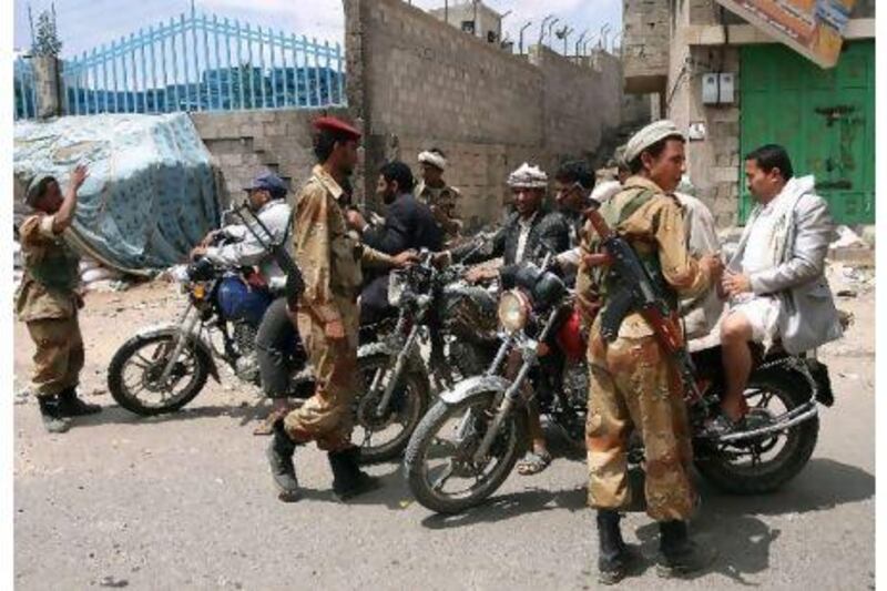 Yemeni soldiers who have defected to back anti-government protesters man a checkpoint near Change Square in Sanaa yesterday.
