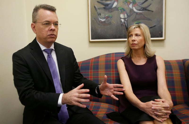 Pastor Andrew Brunson, left, gestures as his wife, Norine, listens during an interview at the headquarters of Christian Broadcasting Network in Virginia Beach, Va., Friday, Oct. 19, 2018. Brunson was recently released from prison in Turkey. (AP Photo/Steve Helber)