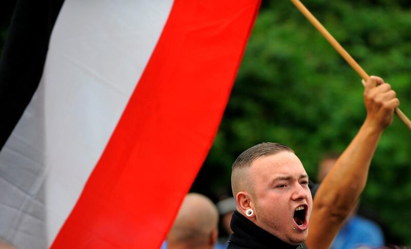 Right extremists attend a neo-Nazi rally on June 17, 2012 in Dresden, eastern Germany, where commemorations were held to remember the uprising from 1953 in the former east German Democratic Republic (GDR). Hundreds of policemen were deployed to keep apart leftist participants of a countermarch. 59 years ago, on June 17, 1953, a strike by East Berlin construction workers provoked a widespread uprising against the regime, which was violently suppressed. June 17 became national holiday in West Germany until the German reunification.      AFP PHOTO / ROBERT MICHAEL / AFP PHOTO / ROBERT MICHAEL