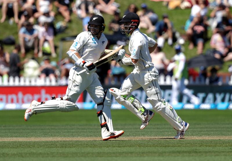 New Zealand's Tom Latham, left, and Kane Williamson run between the wickets while batting during play on day two of the first cricket test between New Zealand and Sri Lanka in Wellington, New Zealand, Sunday, Dec. 16, 2018. (AP Photo/Mark Baker )