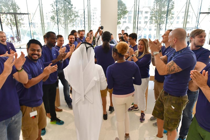 Apple employees cheer as the doors of the Dubai Mall Apple Store open in September 2017 for customers to buy the new iPhone 8. AFP