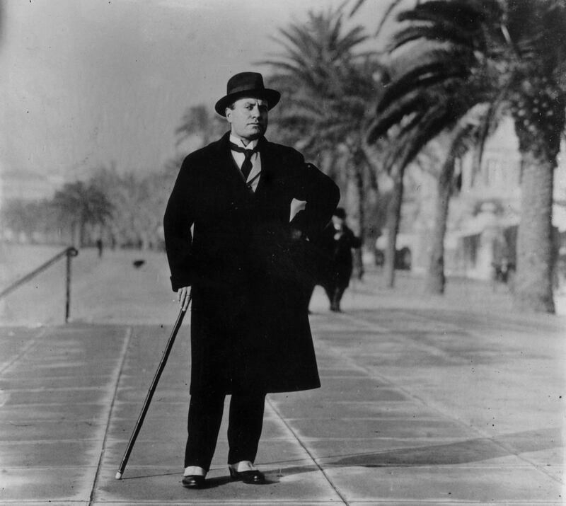 Italian dictator Benito Mussolini (1883 - 1945) wearing spats and an overcoat on the Boulevard at Biarritz, France.    (Photo by Topical Press Agency/Getty Images)