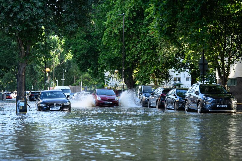 A car makes its way through the flood waters. Getty Images