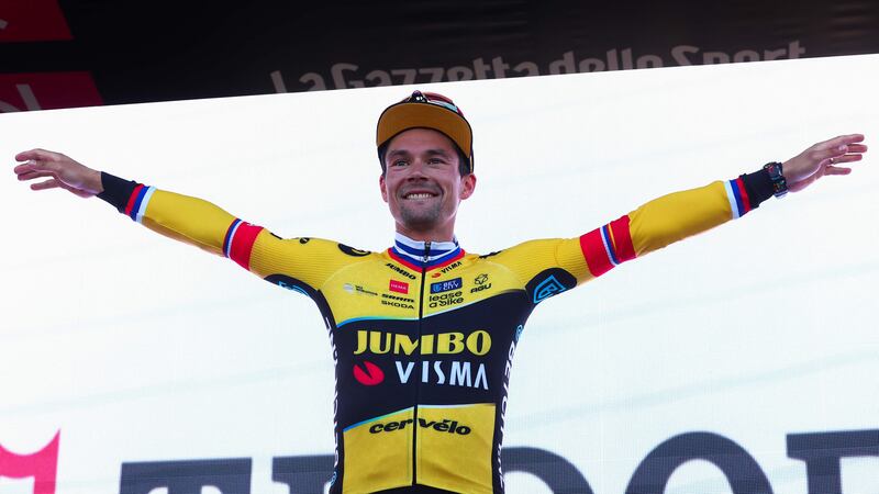 Jumbo-Visma's Slovenian rider Primoz Roglic celebrates on the podium after winning the 20th stage to take the lead of the Giro d'Italia. AFP