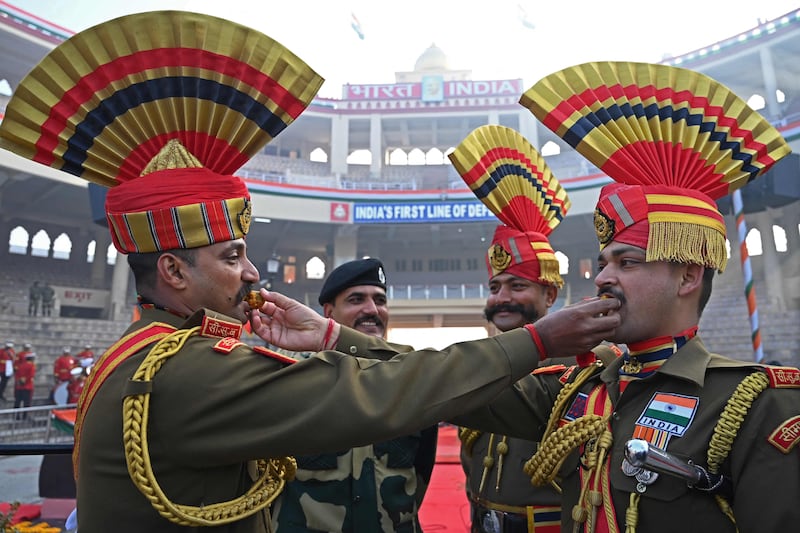 Border Security Force soldiers give each other sweets. AFP