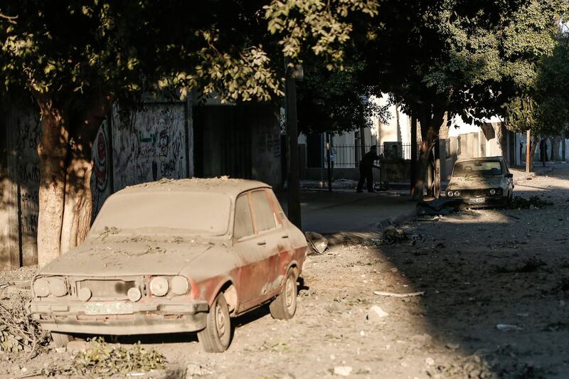 Cars are covered in dust in Gaza City after an Israeli air strike. AFP Photo