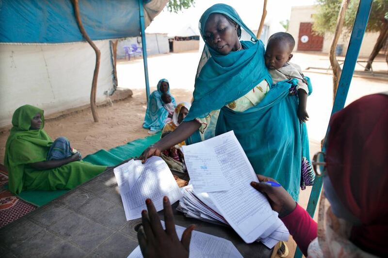 Critics of blanket subsidies say they benefit the wealthy more than the poor – like this mother of a malnourished child in Darfur – diverting public funds from health, education and welfare. Albert Gonzales / EPA

