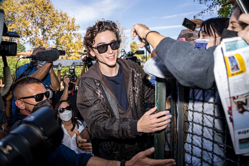 Actor Timothée Chalamet reaches for fans at the photo call of the film "Dune" a the 78th edition of the Venice Film Festival in Venice, Italy. AP Photo