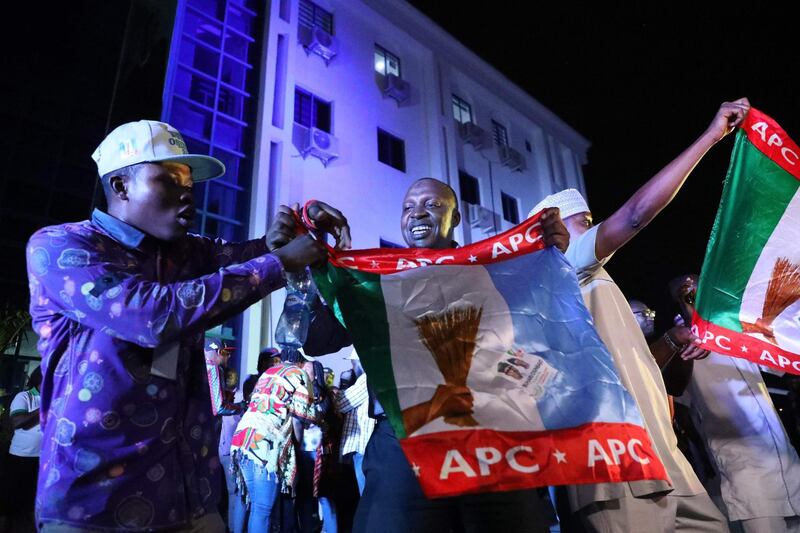 Supporters of the ruling All Progressives Congress (APC) celebrate with party flags in Abuja, Nigeria, after candidate President Mohammadu Buhari was re-elected on February 26, 2019.  Muhammadu Buhari was re-elected Nigeria's president, results showed February 26, 2019, after a delayed poll that angered voters and led to claims of rigging and collusion. Buhari, 76, took an unassailable lead of more than four million votes as the last states were yet to be declared, making it impossible for his nearest rival, Atiku Abubakar, to win. The win was confirmed as Abubakar won in the very last state to declare -- Rivers in the south -- but could not claw back the deficit.
 / AFP / KOLA SULAIMON
