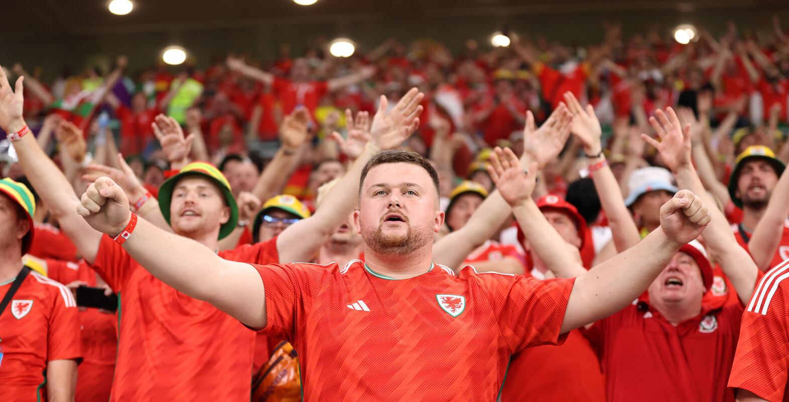 DOHA, QATAR - NOVEMBER 21: Wales fans show their support prior to the FIFA World Cup Qatar 2022 Group B match between USA and Wales at Ahmad Bin Ali Stadium on November 21, 2022 in Doha, Qatar. (Photo by Ryan Pierse / Getty Images)