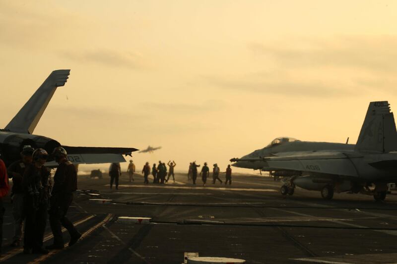 US Navy sailors launch an F/A-18 Super Hornet from the flight deck of the aircraft carrier USS Abraham Lincoln, in Arabian Sea.  Reuters