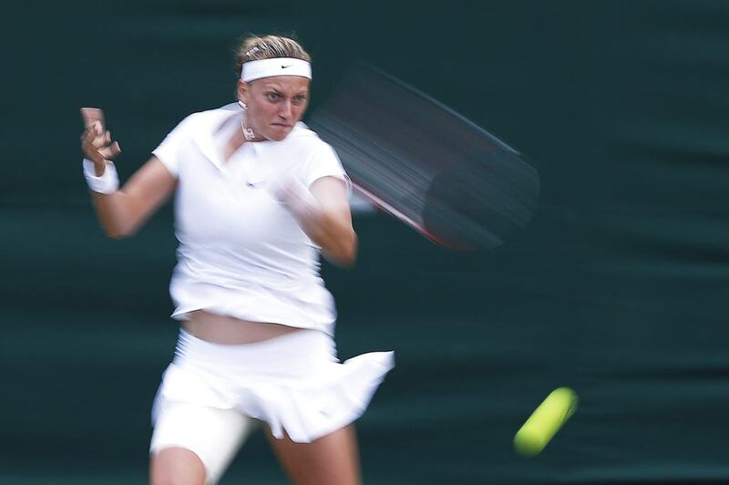 Petra Kvitova of Czech Republic returns to Peng Shuai of China during their fourth round match on Monday at the 2014 Wimbledon Championships. Kvitova won in straight sets. Valdrin Xhemaj / EPA