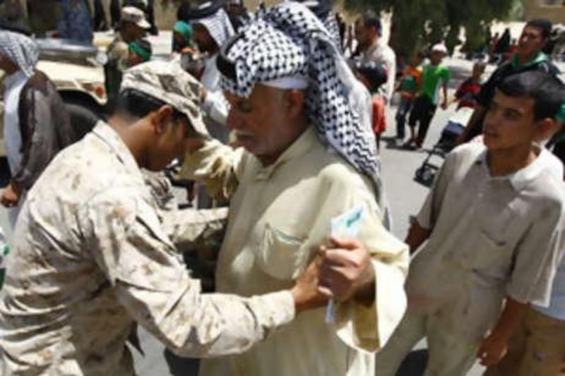 An Iraqi soldier searches a Shiite pilgrim heading to the Imam Moussa al Kadhim shrine yesterday. At least 1 million people are expected to take part today in the pilgrimage in the Iraqi capital.