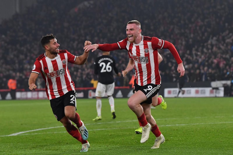 Sheffield United's Oliver McBurnie, right, celebrates after making it 3-3 against Manchester United at Bramall Lane. AFP