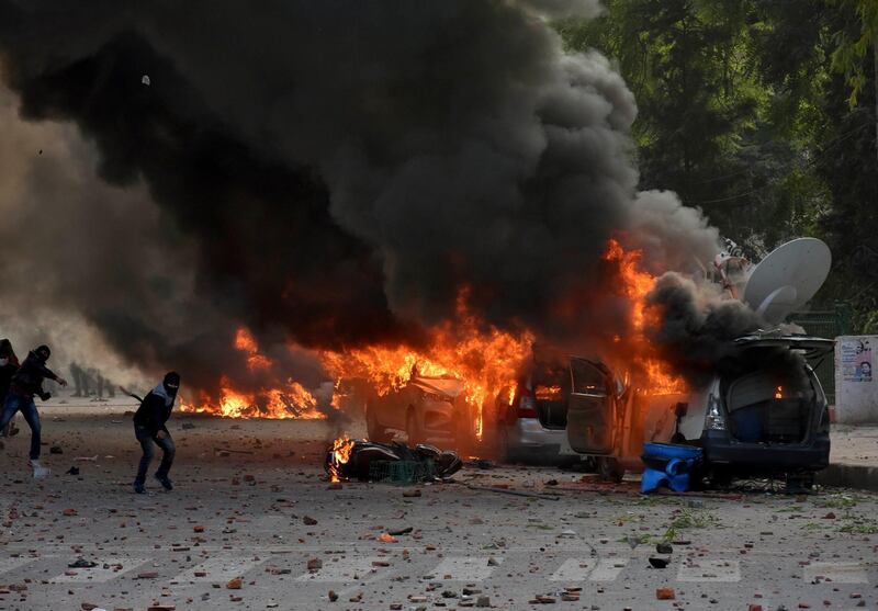 Broadcast vans of television channels go up in flames during protests against India's new citizenship law in Lucknow, India, Thursday, Dec. 19, 2019. Police detained several hundred protesters in some of India's biggest cities Thursday as they defied bans on assembly that authorities imposed to stop widespread demonstrations against a new citizenship law that opponents say threatens the country's secular democracy. (AP Photo)