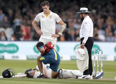 LONDON, ENGLAND - AUGUST 17: Steve Smith of Australia is assessed by Australian Team Doctor Richard Saw after he was struck by a delivery from Jofra Archer of England during day four of the 2nd Specsavers Ashes Test between England and Australia at Lord's Cricket Ground on August 17, 2019 in London, England. (Photo by Ryan Pierse/Getty Images)