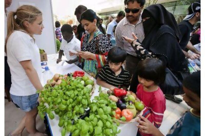 Families shop for organic vegetables at the Ripe stall at The Market@Masdar City yesterday.