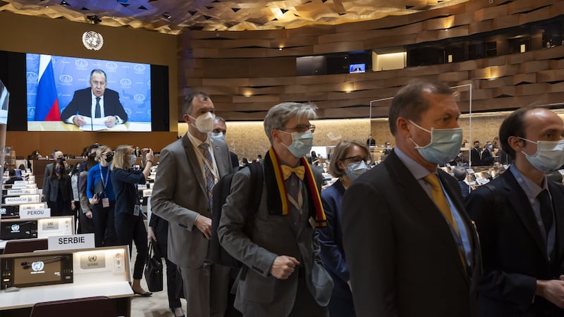 Ambassadors and diplomats walk out as Russia's Foreign Minister Sergey Lavrov (on screen) speaks during a recorded message at the 49th session of the UN Human Rights Council in Geneva. EPA