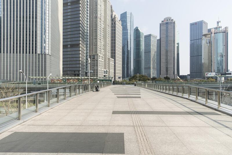 Skyscraper buildings stand beyond an empty pedestrian bridge that connects office buildings in the Lujiazui Financial District in Shanghai, China, on Wednesday, Feb. 5, 2020. The death toll from the coronavirus outbreak climbed toward 500 as confirmed cases worldwide neared 25,000. Photographer: Qilai Shen/Bloomberg