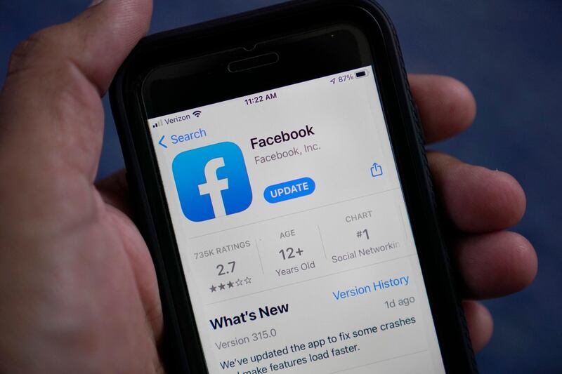 The Facebook app is shown on a smart phone, Friday, April 23, 2021, in Surfside, Fla.  Facebook says, Thursday, May 27,  it will no longer remove claims that COVID-19 is man-made or manufactured from its apps. The change comes â€œin light of ongoing investigations into the origin of COVID-19 and in consultation with public health experts,â€ Facebook said.  .(AP Photo/Wilfredo Lee)