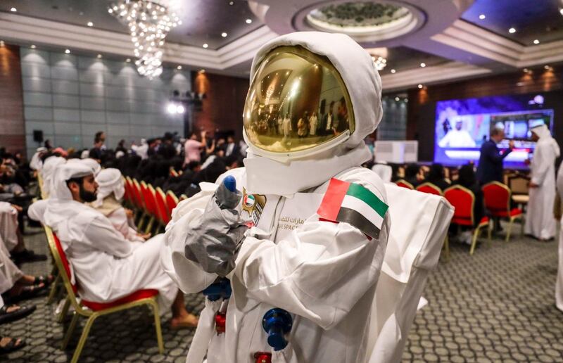 Saif Al Maskari dresses in a space suit to watch the launch at Abu Dhabi National Exhibition Centre on Wednesday. Victor Besa / The National