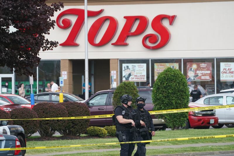 Police secure the area around the Buffalo supermarket where the shooting took place. AP