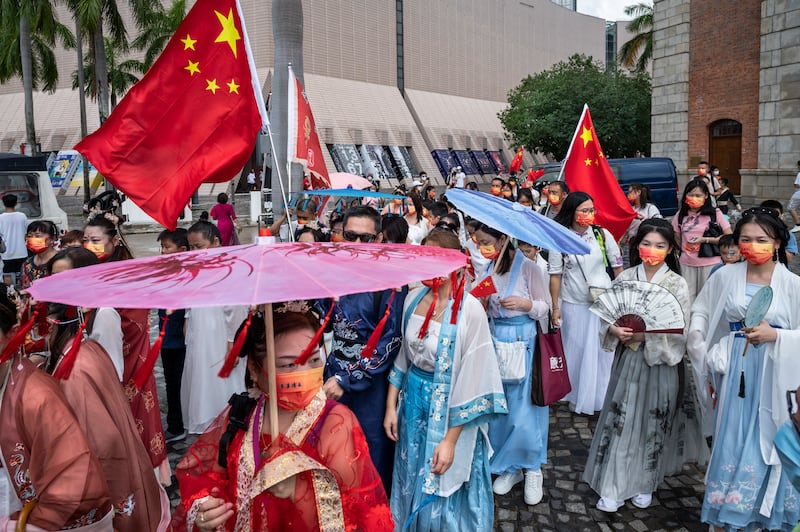 People dressed in traditional Han costumes celebrate China's 73rd National Day in Hong Kong. EPA