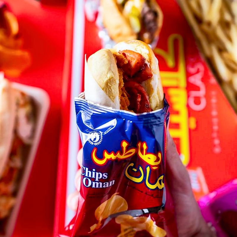 The hotdog fareej from Burger28 is served in a Chips Oman wrapper. Courtesy Burger28