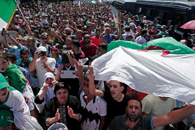 Algerian demonstrators take to the streets in the capital to protest against the government, in Algeria, Friday, Sept. 6, 2019. Tens of thousands of protesters piled into the streets of the Algerian capital and other cities Friday, the 29th straight week of demonstrations, with many saying "no" to the powerful army chief's call for presidential elections before the end of the year. (AP Photo/Fateh Guidoum)