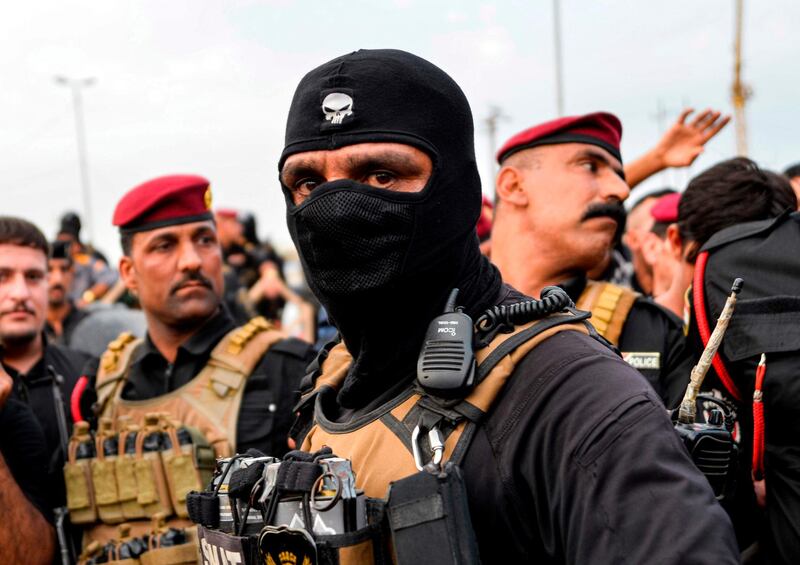 Members of the Iraqi security forces confront protesters during a demonstration against corruption and lack of basic services in the city of Najaf. AFP